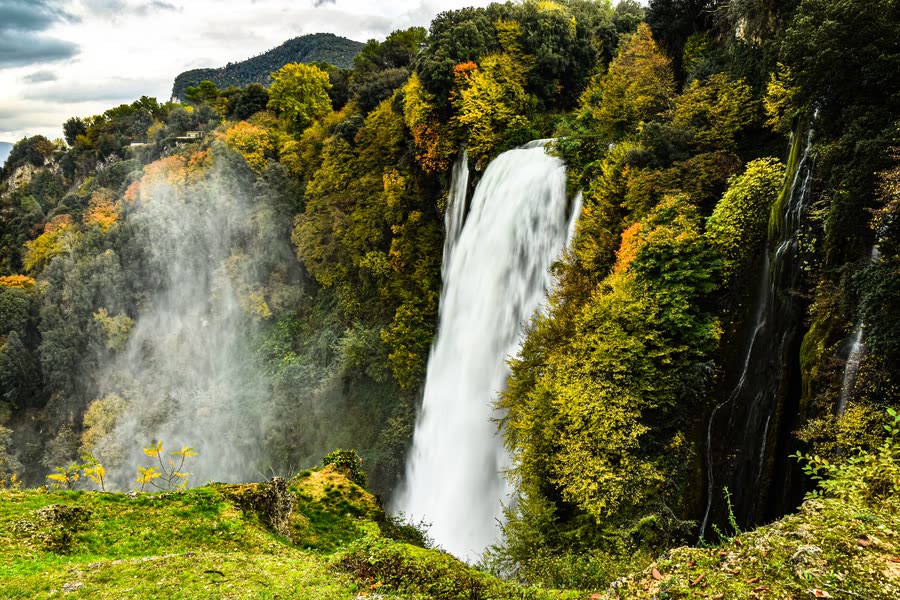 The Marmore Falls surrounded by green woods