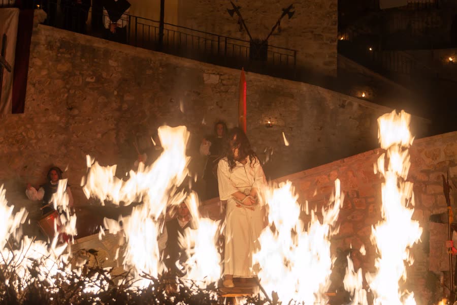 Performers among fire and sparks at a night re-enactment